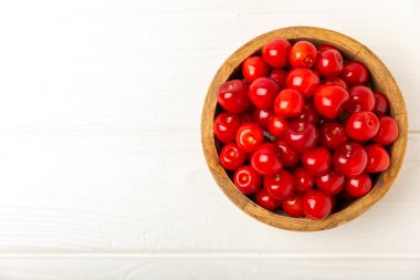 Kirazlar. Ahşap kaplamalı taze kirazlar ve yapraklar. Taze organik kiraz yığını. Böğürtlen ve meyve. Vejetaryen. Sağlıklı beslenme. Mesaj için yer. Boşluğu kopyala