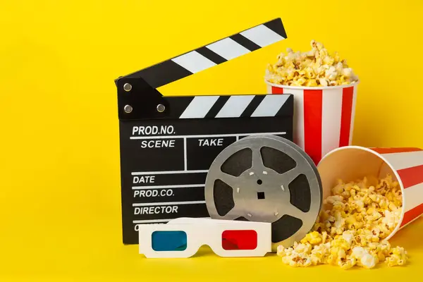 stock image Tasty popcorn in buckets and cold cola drinks with cinema tickets, movie clapper and 3D eyeglasses on a bright colored background. Cinema concept. Watching a movie.Place for text. Copy space