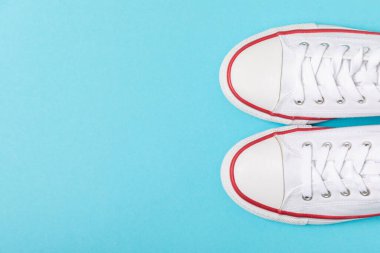 Beyaz ayakkabılar, parlak renkli arka planda spor ayakkabılar. Tek cinsiyetli spor ayakkabıları. Üst Manzara. Mesaj için yer var. Uzayı kopyala. Güzel spor ayakkabılar. Moda ayakkabılar