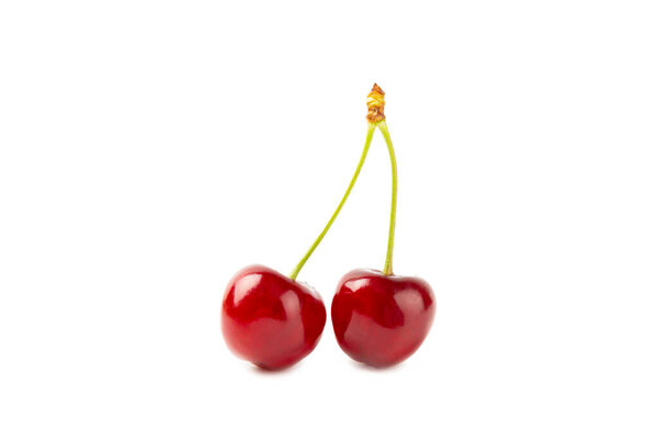Cherry isolated. Fresh ripe cherries with leaves isolated on a white background.Sweet cherries pile. Berries and fruits. Vegan. Healthy eating.