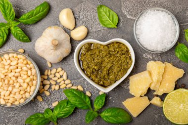 Pesto. Ahşap kaplamalı İtalyan fesleğen sosu. Pesto sosu içeriği: taze fesleğen, çam fıstığı, parmesan peyniri ve zeytinyağı. Metin için boşluk. Boşluğu kopyala.