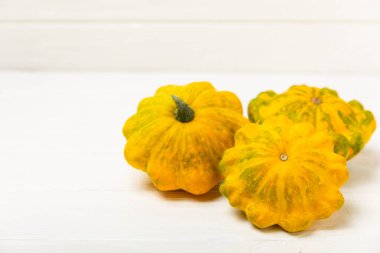 Dokulu mutfak masasında patypan kabağı. Kabak. Arka planda taze organik pattypan kabakları. Vejetaryen. Çiftçi Pazarı. Patisson. Mesaj için yer var. Boşluğu kopyala.