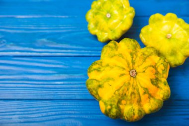 Dokulu mutfak masasında patypan kabağı. Kabak. Arka planda taze organik pattypan kabakları. Vejetaryen. Çiftçi Pazarı. Patisson. Mesaj için yer var. Boşluğu kopyala.