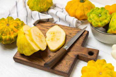 Pattypan zucchini on a textured kitchen table. squash. Fresh organic pattypan squashes on background. Vegan. Farmer's Market. Patisson. Space for text. Copy space. clipart