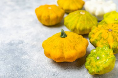 Dokulu mutfak masasında patypan kabağı. Kabak. Arka planda taze organik pattypan kabakları. Vejetaryen. Çiftçi Pazarı. Patisson. Mesaj için yer var. Boşluğu kopyala.