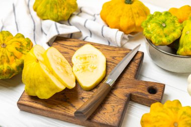 Pattypan zucchini on a textured kitchen table. squash. Fresh organic pattypan squashes on background. Vegan. Farmer's Market. Patisson. Space for text. Copy space. clipart