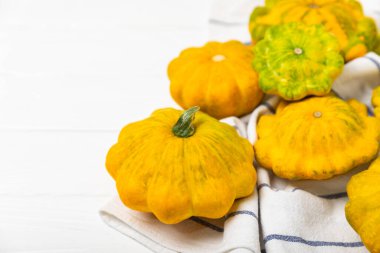 Pattypan zucchini on a textured kitchen table. squash. Fresh organic pattypan squashes on background. Vegan. Farmer's Market. Patisson. Space for text. Copy space. clipart