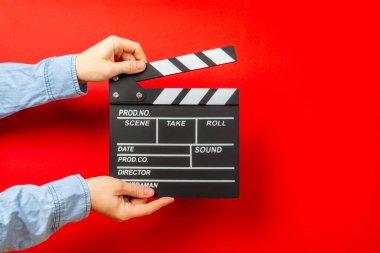 Movie clapper. Movie clapper in hands on bright colored background. Concept of rest and entertainment. Concept of cinema. Film director. Producer. Business and profession. Place for text. Copy space clipart