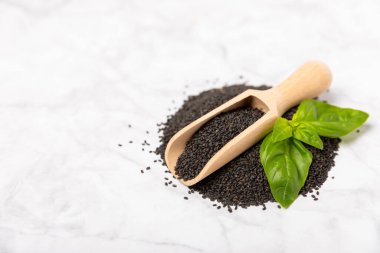 Dökümlü ahşap arka planda fesleğen tohumları. Yakın plan. Süper yemek. Ocimum bazilika. Organik fesleğen tohumu. selasih. Mesaj için yer var. Boşluğu kopyala.