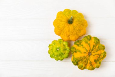 Pattypan zucchini on a textured kitchen table. squash. Fresh organic pattypan squashes on background. Vegan. Farmer's Market. Patisson. Space for text. Copy space. clipart