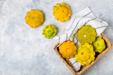 Pattypan zucchini on a textured kitchen table. squash. Fresh organic pattypan squashes on background. Vegan. Farmer's Market. Patisson. Space for text. Copy space. clipart