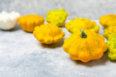 Pattypan zucchini on a textured kitchen table. squash. Fresh organic pattypan squashes on background. Vegan. Farmer's Market. Patisson. Space for text. Copy space. clipart