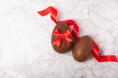 Arka planda paskalya çikolatalı yumurtası. Paskalya kutlaması. Paskalya çikolatalı tavşan. Çikolatalı tatlı yumurta. Şekerler ahşap masanın üzerinde. Mesaj için boşluk. Boşluğu kopyala. Hediye. Pankart.