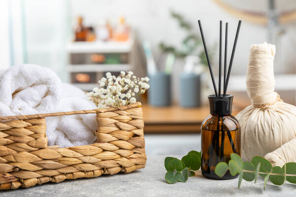 Aromatic reed air freshener on wooden table.Diffuser with natural fruity, floral, spicy aroma.interior scent. Luxury perfume for the home.Orange, lime, coffee, cinnamon, star anise, vanilla and orchid