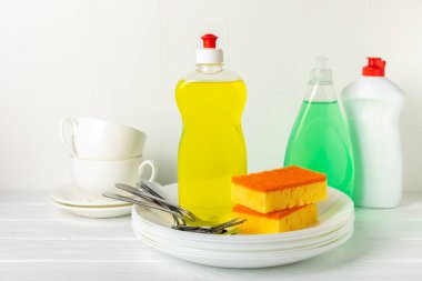 Arka planda renkli bulaşık süngerleri. Mutfak süngeri. Temizlik konsepti, temizlik hizmeti. Bulaşık deterjanı ve temiz ve kirli tabaklar. Metin için yer, kopyalama alanı. Bulaşıkları yıka..