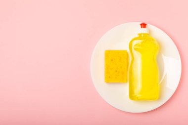 Arka planda renkli bulaşık süngerleri. Mutfak süngeri. Temizlik konsepti, temizlik hizmeti. Bulaşık deterjanı ve temiz ve kirli tabaklar. Metin için yer, kopyalama alanı. Bulaşıkları yıka..