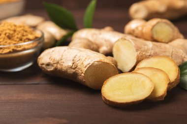 Ahşap arka planda taze zencefil. Kuru zencefil. Ballı ve limonlu zencefil dilimi. Zencefil kökü. Geleneksel alternatif tıp, bağışıklık için çay. Baharat ve baharat konsepti. Boşluğu kopyala.