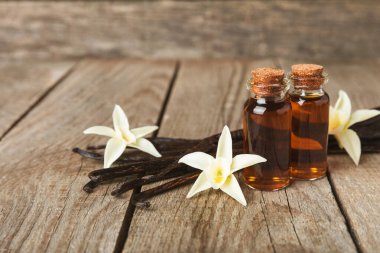 Tahta bir masanın üzerinde cam kaplama vanilya özü. Kek ve tatlı için vanilya özü. Aromatik ev yapımı vanilya özü. Kapatın. Mesajı yerleştir. Boşluğu kopyala.