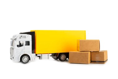 Sarı kamyonlar ve karton kutular beyaz arka planda izole edilmiş. Lojistik, teslimat ve ulaşım konuları. Dünyanın dört bir yanındaki mağazaya mal ya da ürün teslimatı. Karton kutu..