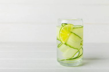 Salatalık suyu, limon, nane ve ahşap bir masada. İçme bardağında dilimlenmiş salatalık ile karıştırılmış su. Tonik ferahlatıcı bir içecek. Salatalık limonata. Doğal soğutma içeceği. Boşluğu kopyala.