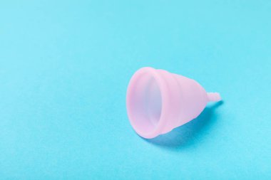 Aybaşı bardağı parlak bir arka planda. Hijyenik peçeteler, tamponlar ve regl kupası. Kritik günler, regl dönemi kavramı. Kadın hijyen ürünü. Kadın sağlığı kavramı. Adet öncesi sendromu. Boşluğu kopyala