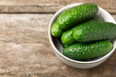 Ahşap arka planda salatalık. Arka planda bir parça salatalık. Taze organik yeşil salatalık turşusu. Vejetaryen. Salata malzemesi. Çiftlik sebzeleri. Sebzeleri bıçakla kes. Mesaj için yer var. Boşluğu kopyala