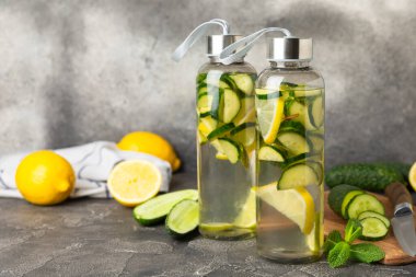 Salatalık suyu, limon, nane ve ahşap bir masada. İçme bardağında dilimlenmiş salatalık ile karıştırılmış su. Tonik ferahlatıcı bir içecek. Salatalık limonata. Doğal soğutma içeceği. Boşluğu kopyala.