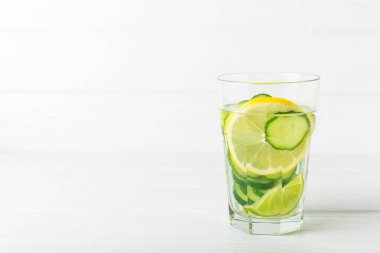 Salatalık suyu, limon, nane ve ahşap bir masada. İçme bardağında dilimlenmiş salatalık ile karıştırılmış su. Tonik ferahlatıcı bir içecek. Salatalık limonata. Doğal soğutma içeceği. Boşluğu kopyala.