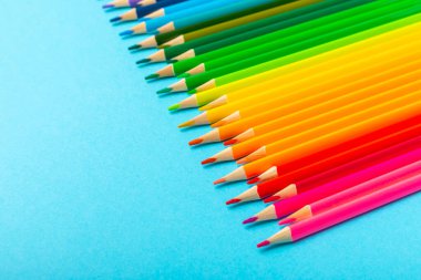 Renkli arka planda renkli kalemler. Boyama için ekipman. Yaratıcılık için kırtasiye malzemesi. Okula dönüyorum. Flatlay. Çocukların Yaratıcılığı ve Eğitimi. Rainbow.Mesaj için yer var. Boşluğu kopyala.