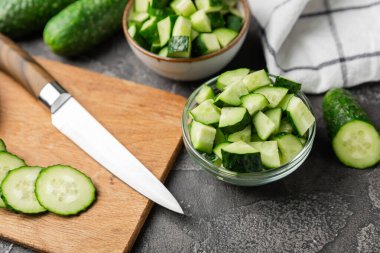 Ahşap arka planda salatalık. Arka planda bir parça salatalık. Taze organik yeşil salatalık turşusu. Vejetaryen. Salata malzemesi. Çiftlik sebzeleri. Sebzeleri bıçakla kes. Mesaj için yer var. Boşluğu kopyala