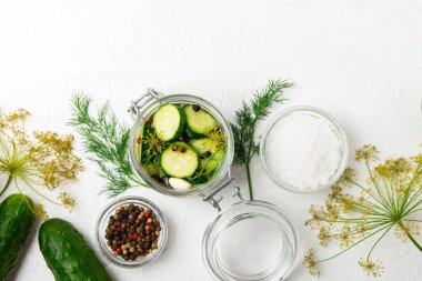 Ahşap bir arka planda kavanozda taze tuzlanmış ev yapımı salatalıklar. Dereotlu, sarımsaklı ve biberli salatalık turşusu. Konserve salatalık, salatalık ve penis. Ev yapımı koruma..