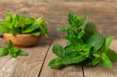 Naneli. Ahşap arka planda taze organik nane yaprakları. Nane yaprakları. Nane şekeri. Yakın plan. Mesaj için yer var. Boşluğu kopyala.