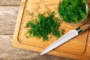 Ahşap arka planda Dill. Taze organik sebzeler. Dill çiftliği. Dereotu yapraklarını kes. Bahar genç deresi sürüsü. Vitaminler. İplik. Aromatik mutfak baharatı. Mesaj için yer. Boşluğu kopyala