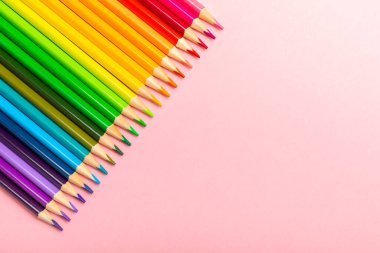 Renkli arka planda renkli kalemler. Boyama için ekipman. Yaratıcılık için kırtasiye malzemesi. Okula dönüyorum. Flatlay. Çocukların Yaratıcılığı ve Eğitimi. Rainbow.Mesaj için yer var. Boşluğu kopyala.