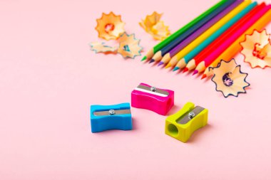 Renkli arka planda kalem açacağı. Kalem ve kalem talaşı. Kırtasiye malzemeleri. Okul malzemeleri. Okul ürünleri. Düz yatıyordu. Mesaj için yer. Boşluğu kopyala.