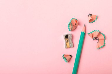 Renkli arka planda kalem açacağı. Kalem ve kalem talaşı. Kırtasiye malzemeleri. Okul malzemeleri. Okul ürünleri. Düz yatıyordu. Mesaj için yer. Boşluğu kopyala.