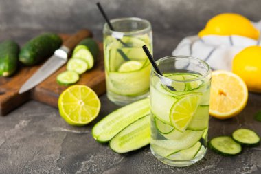 Salatalık suyu, limon, nane ve ahşap bir masada. İçme bardağında dilimlenmiş salatalık ile karıştırılmış su. Tonik ferahlatıcı bir içecek. Salatalık limonata. Doğal soğutma içeceği. Boşluğu kopyala.