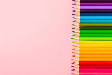 Renkli arka planda renkli kalemler. Boyama için ekipman. Yaratıcılık için kırtasiye malzemesi. Okula dönüyorum. Flatlay. Çocukların Yaratıcılığı ve Eğitimi. Rainbow.Mesaj için yer var. Boşluğu kopyala.