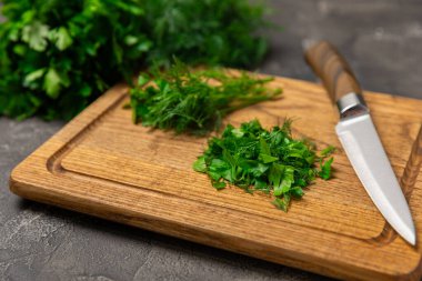 Doku masasında Dill ve Maydanoz. Maydanozla dereotu karıştırdım. Taze aromalı baharatlı sebzeler. Baharatlar ve bitkiler. Mesaj için yer var. Boşluğu kopyala