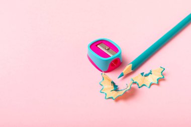 Renkli arka planda kalem açacağı. Kalem ve kalem talaşı. Kırtasiye malzemeleri. Okul malzemeleri. Okul ürünleri. Düz yatıyordu. Mesaj için yer. Boşluğu kopyala.