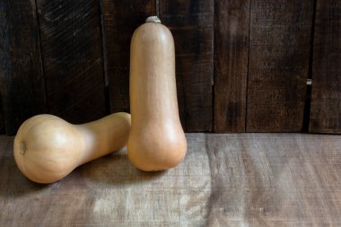 Butternut squash isolated on wood background top view, close up, healthy food concept.