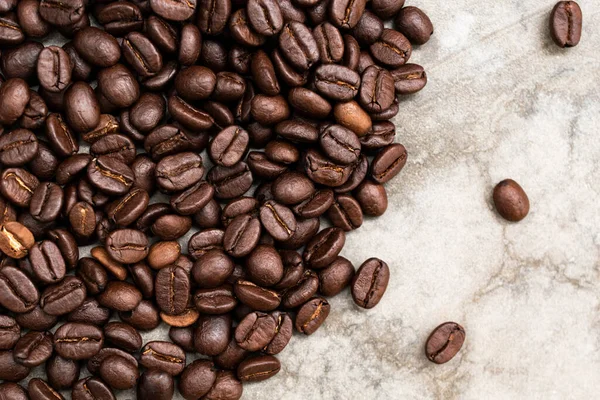 Roasted coffee bean on stone background copy space, top view, food and drink concept.