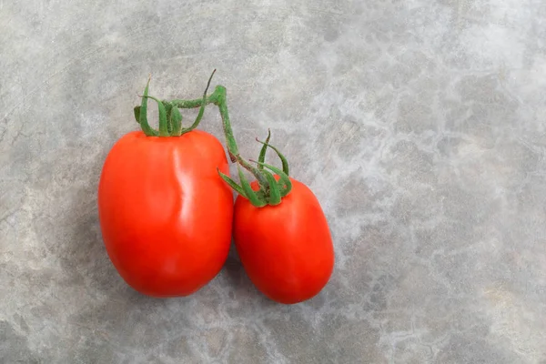 Tomato isolated on stone background top view, healthy food concept.