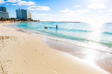 Cancun Otel Bölgesi 'ndeki Playa Chacmool' un güzel manzarası yumuşak beyaz kum, turkuaz Karayip suları ve kırsal bir cankurtaran kulesi gösteriyor. Fotoğraf, yakınlardaki yerlerden daha az kalabalık olan bu halk plajının huzurlu atmosferini yakalıyor. Uzun oteller!