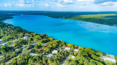 Bacalar, Mexico, Quintana Roo, Beautiful blue lake with a town on the shore. The water is calm and the sky is clear
