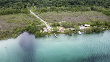 Bacalar, Mexico, Quintana Roo, Beautiful blue lake with a small village on the shore. The water is calm and the sky is clear