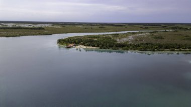 Bacalar, Mexico, Quintana Roo, Beautiful blue lake with a small island in the middle. The island is surrounded by trees and the water is calm