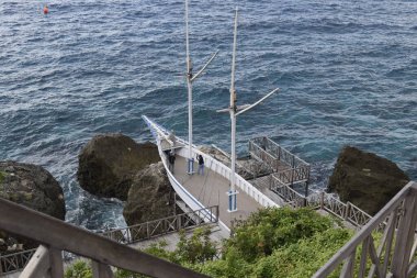 Wooden boat on a cliff to take pictures and enjoy the sea view in the tourist area of Tanjung Bira Indonesia. asian travel