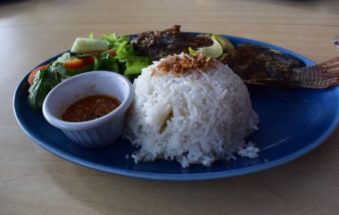 Delicious fried tilapia with white rice served on the table