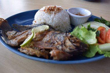 Delicious fried tilapia with white rice served on the table